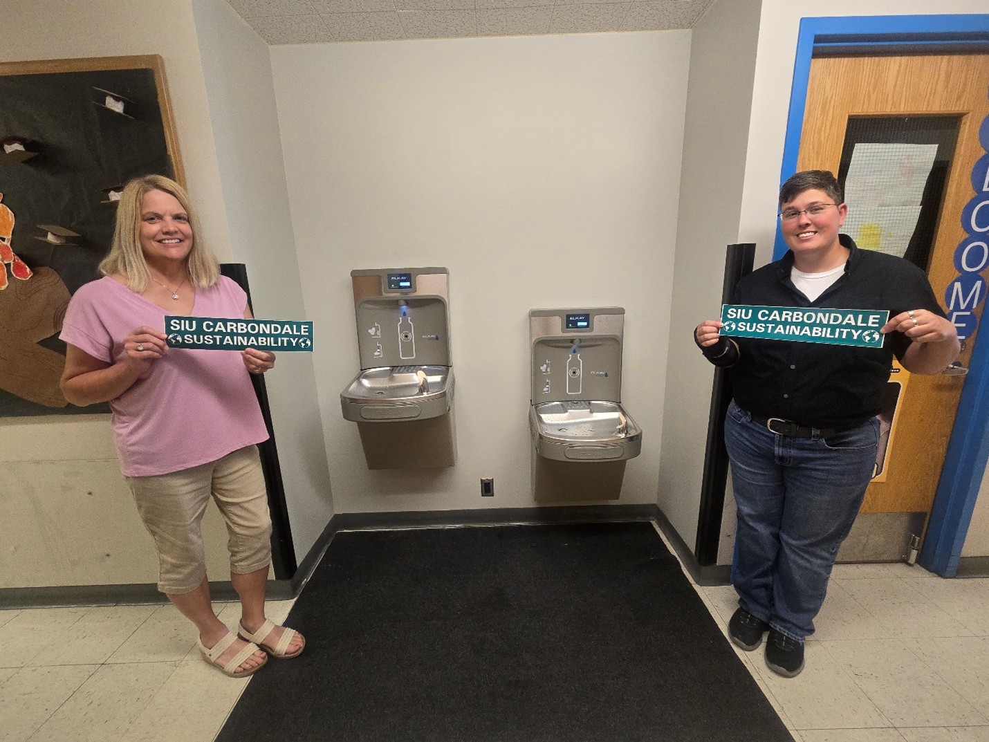 Rainbow End Employees staining in front of their New water bottle refill stations